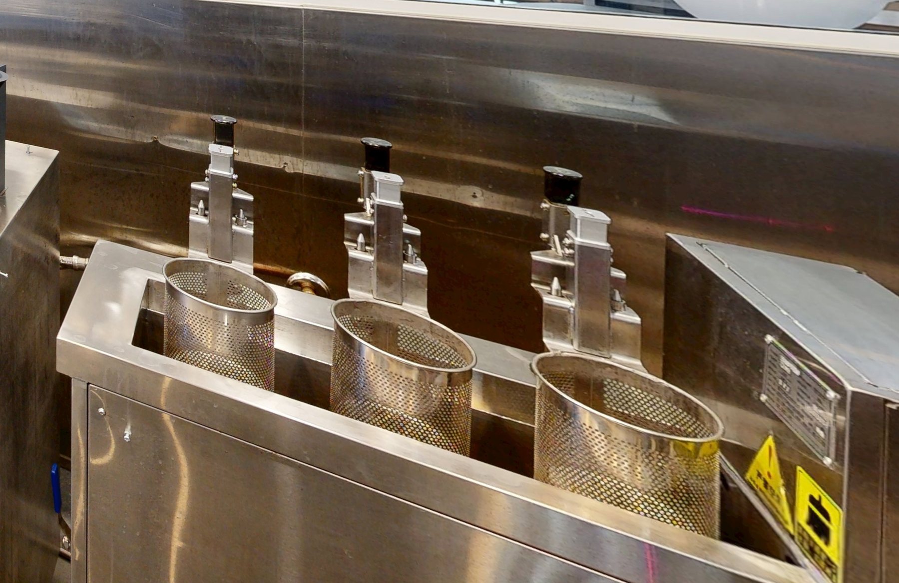 The row of noodle baths with lift baskets